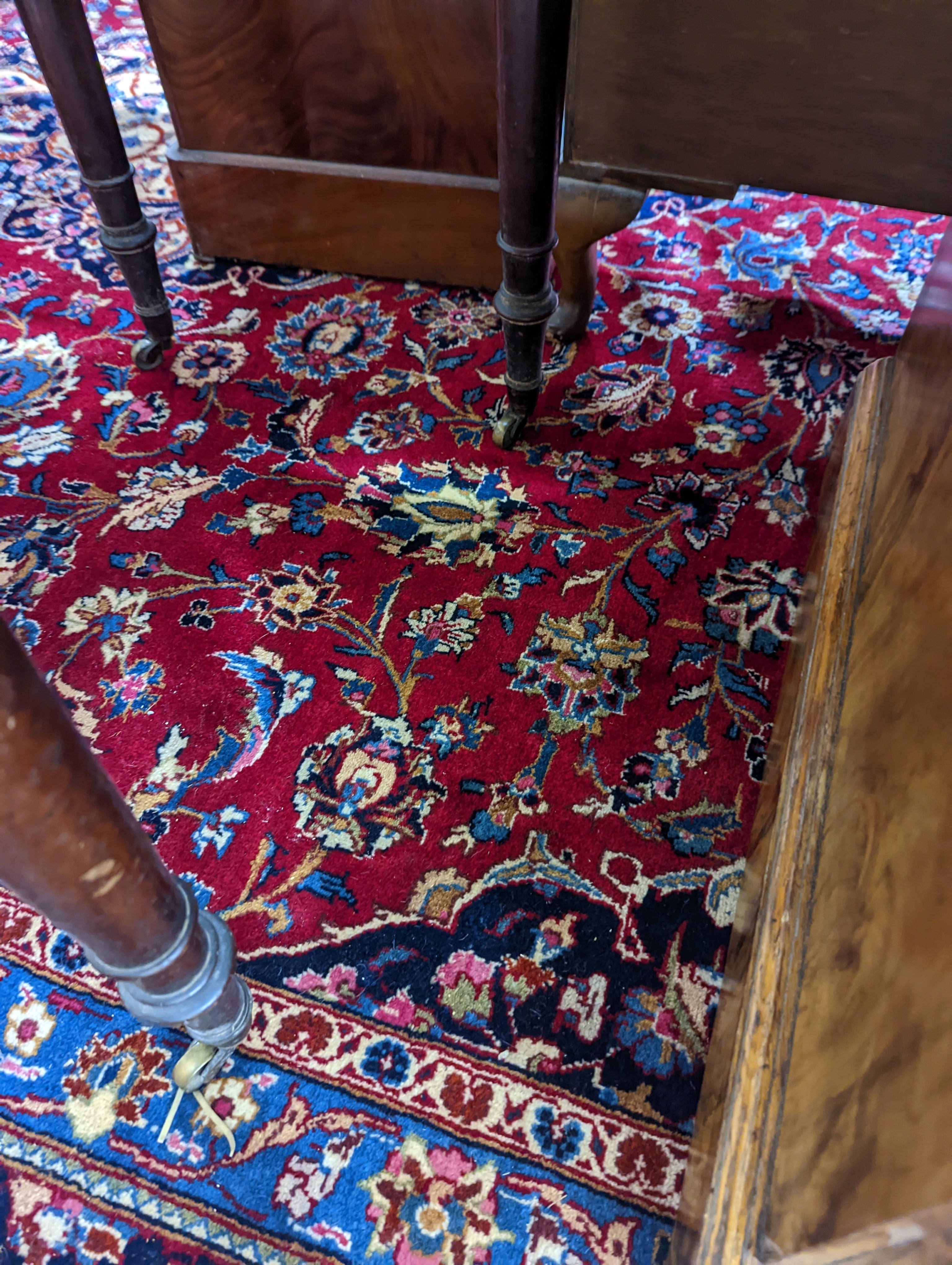 A Kashan burgundy ground carpet, 380 x 300cm